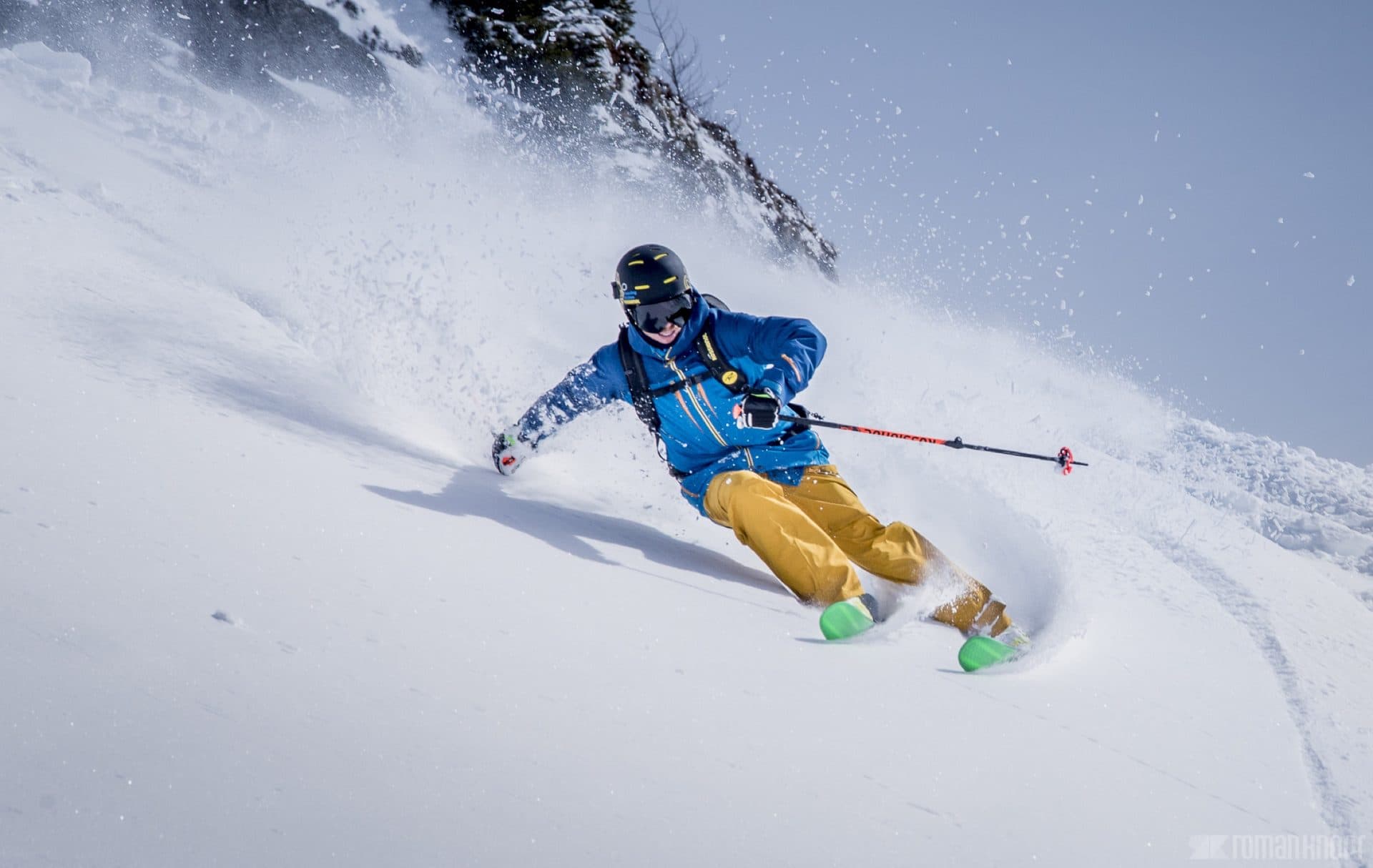 Rider carving a turn on a bluebird day in the Wasatch