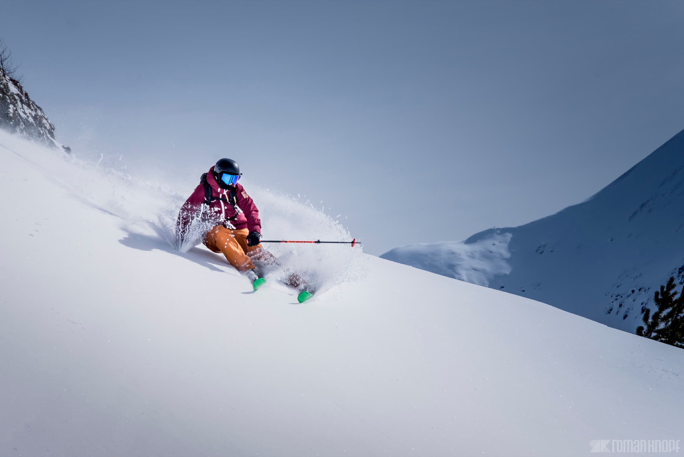 Skier carving a powder turn in the Wasatch Mountains near The Lifthouse