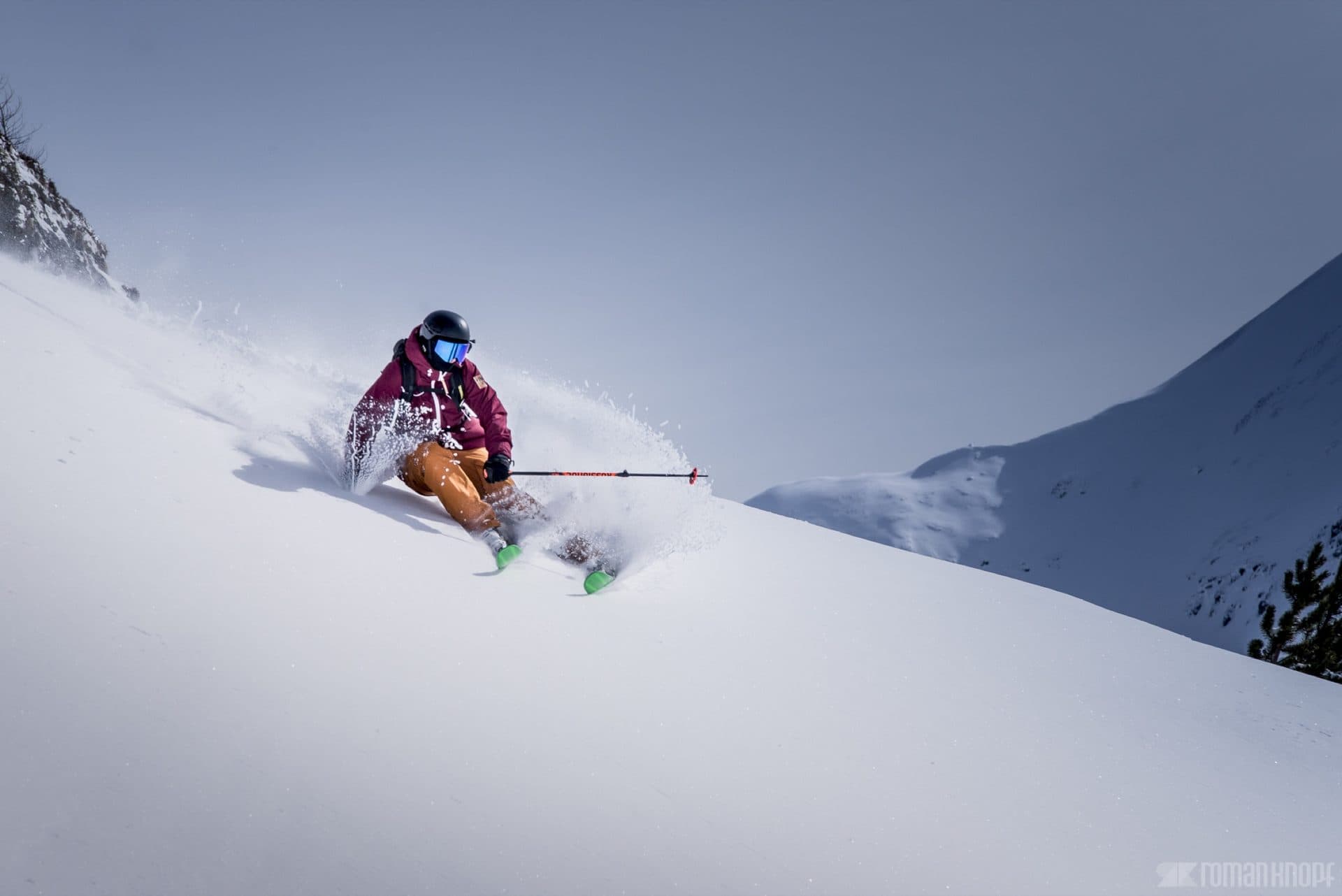 Skiers on a groomed run in the Wasatch mountains above Salt Lake City